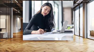 Beautiful confident asian business woman working with laptop Hands typing  keyboard. Professional investor working new start up project. business planning in office. Technology business Wall mural